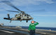Airman salutes as MH-60S Sea Hawk helicopter departs poster print.