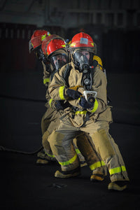 Sailors practicing firefighting drills in the hangar bay of USS Nimitz poster print.