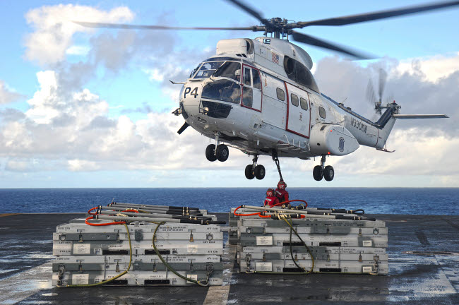 Sailors attaching cargo legs to SA330J Puma helicopter poster print