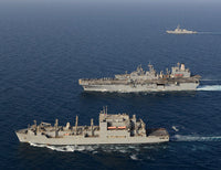 USNS Robert E Peary conducting a vertical replenishment with USS Bataan poster print