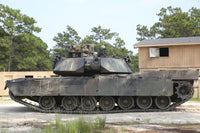 M1A1 Abrams tank in a defensive position on simulated enemy town poster print.