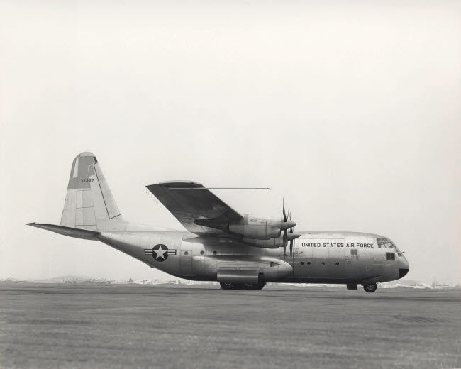 YC-130 First Flight Poster Print by Stocktrek Images showcasing the aircraft's inaugural flight.