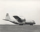 YC-130 First Flight Poster Print by Stocktrek Images showcasing the aircraft's inaugural flight.