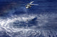 MH-60S Seahawk lowers a rescue swimmer into the water poster print