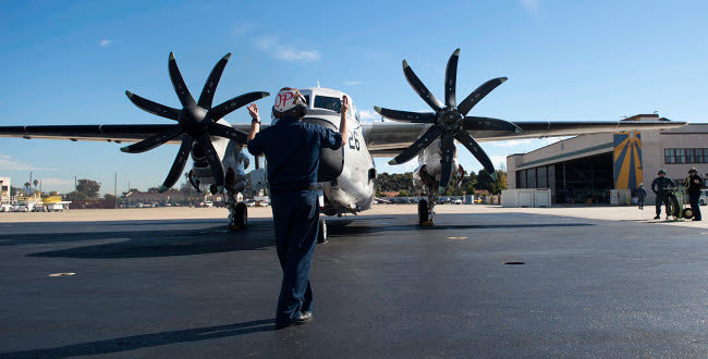 US Sailor Signaling to C-2A Greyhound Aircraft Poster Print