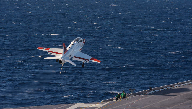 US Navy T-45C Goshawk performing a touch-and-go landing poster print.