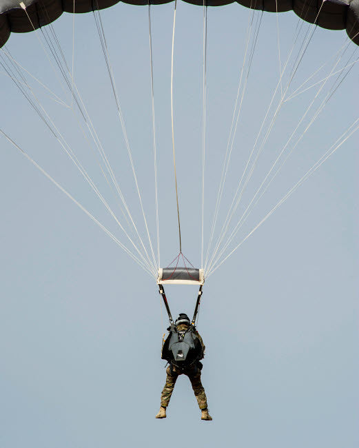 US Air Force pararescueman descending during jump training poster print.