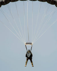 US Air Force pararescueman descending during jump training poster print.