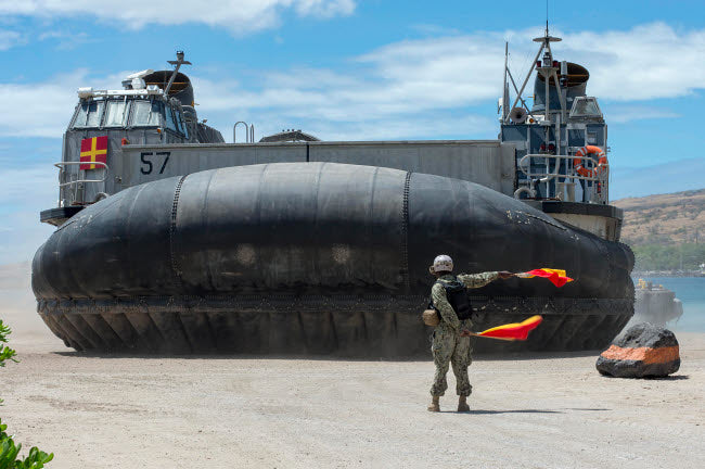 US Navy Seaman directing a landing craft air cushion poster print.