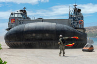US Navy Seaman directing a landing craft air cushion poster print.