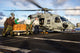 Sailors loading relief supplies onto an MH-60S Sea Hawk helicopter poster print.