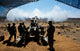 US Marines firing M777A2 Howitzer poster print showcasing military action.