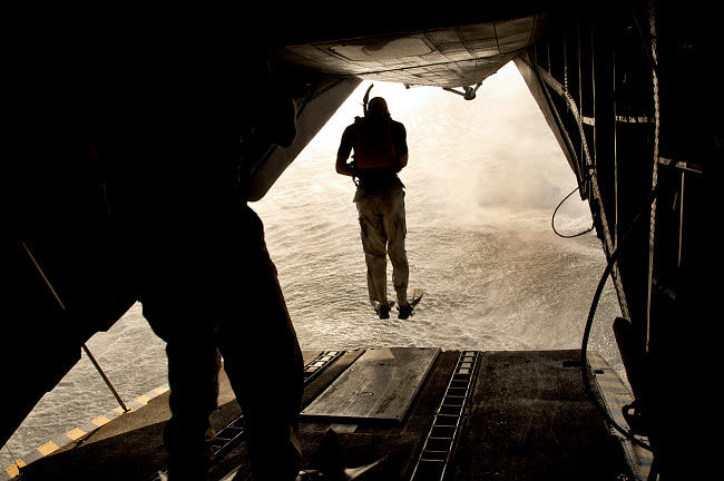 US Air Force pararescuemen jumping from a CH-53 Sea Stallion poster print.