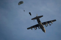 Personnel jumping from a C-130 Hercules during a static-line jump poster print.