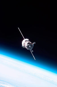 Soyuz TMA-6 spacecraft poster print with Earth's horizon and space background.