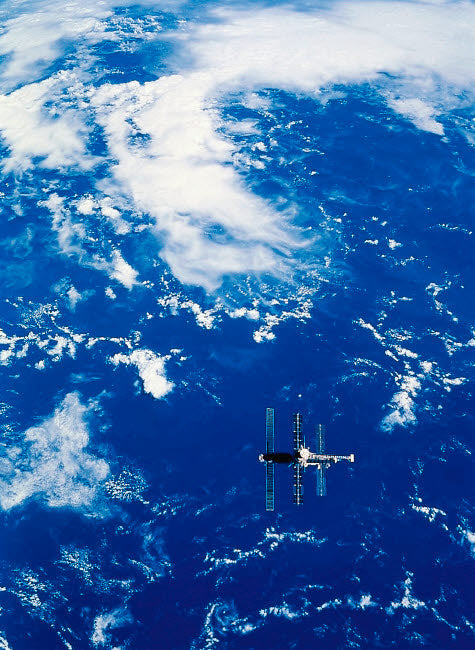 Space Station in orbit over Earth poster print showcasing vibrant colors and details.