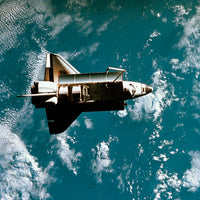 Space Shuttle in Space Poster Print showcasing the shuttle in the cosmos.