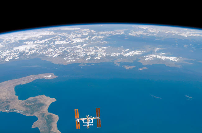 International Space Station Poster Print by Stocktrek Images showcasing Earth from space.