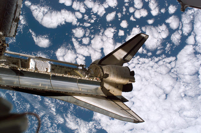 Space Shuttle Discovery Poster Print showcasing the iconic shuttle in flight.
