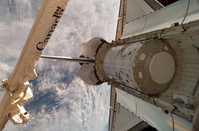Poster print of The Harmony node in Space Shuttle Discovery's cargo bay