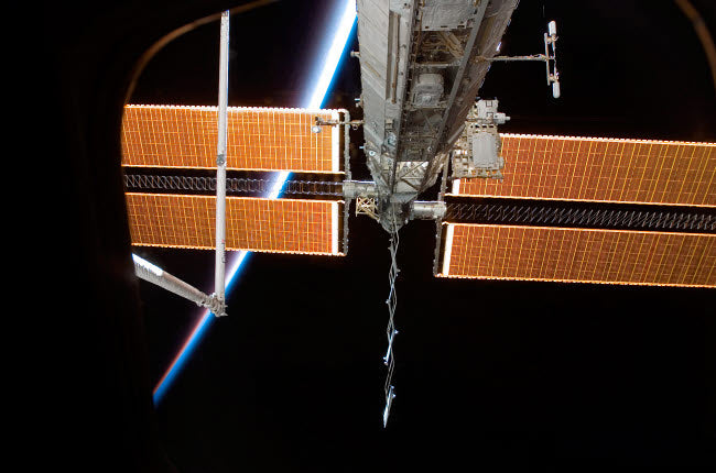 International Space Station poster print with Earth's airglow background