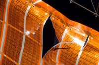 Close-up of a tear in solar array material on the International Space Station poster print.