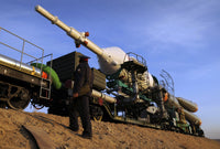 Soyuz TMA-13 spacecraft launch poster print showing transportation to launch pad at Baikonur Cosmodrome.