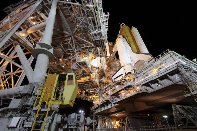 Technicians rolling the rotating service structure of Space Shuttle Discovery poster print.