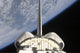 Space Shuttle Endeavour partial view poster print against Earth's horizon.