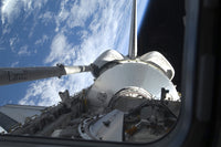 Space Shuttle Discovery Poster Print with Earth's horizon as backdrop.