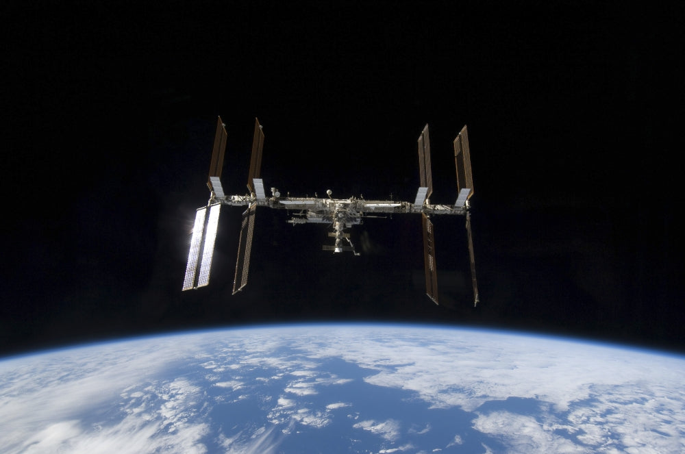 International Space Station and Space Shuttle Discovery poster print, showcasing Earth and space.