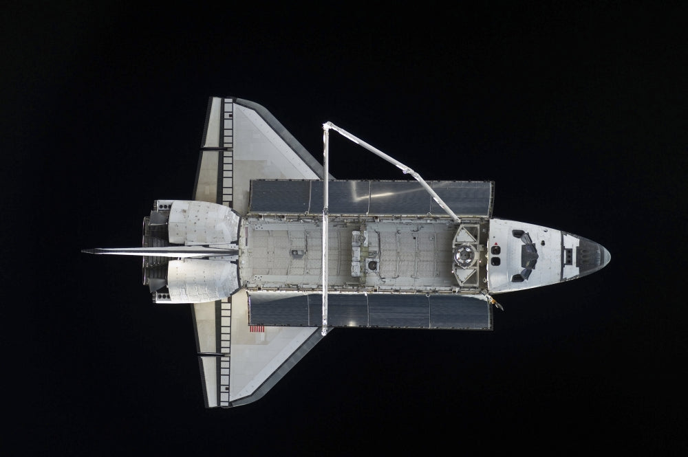 Space Shuttle Atlantis against the blackness of space poster print.