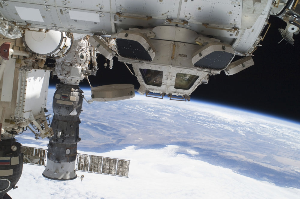 Components of the International Space Station above the Pacific Ocean Poster Print