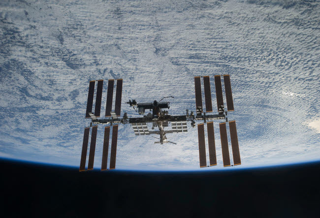 International Space Station Poster Print above Earth by Stocktrek Images