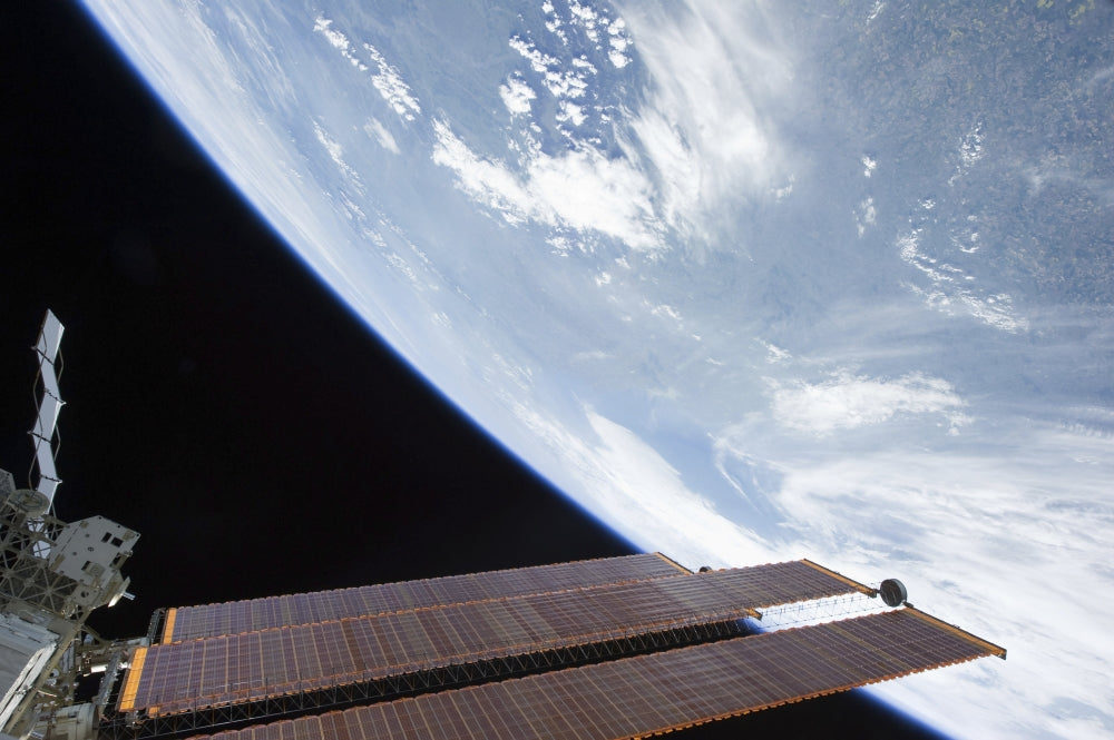 International Space Station solar array panels with Earth in the background poster print.