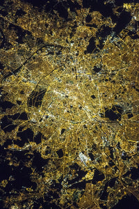 View from space of Paris, France, showing city lights and street grid pattern at night.