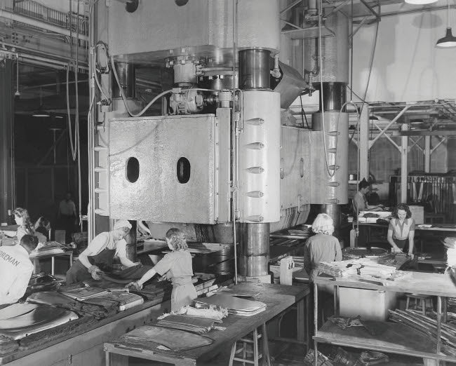 Women working heavy machinery at aircraft assembly plant circa 1942 poster print.