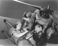 Aviation mechanic rebuilding an airplane engine poster print