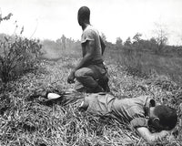 Poster print of a young American lieutenant treated by a medic in Vietnam, 1966.