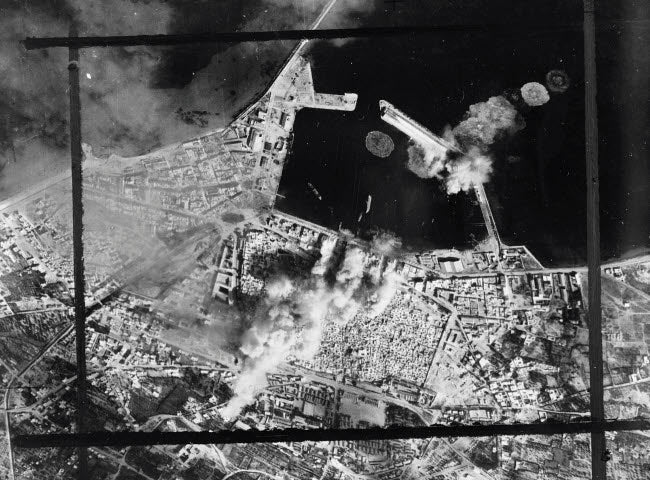 Aerial photograph of bombing hits on a pierhead in Sousse, Tunisia, circa 1943.