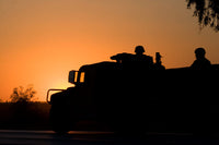 US Army Humvee with soldiers at sunset poster print by Terry Moore