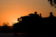 US Army Humvee with soldiers at sunset poster print by Terry Moore