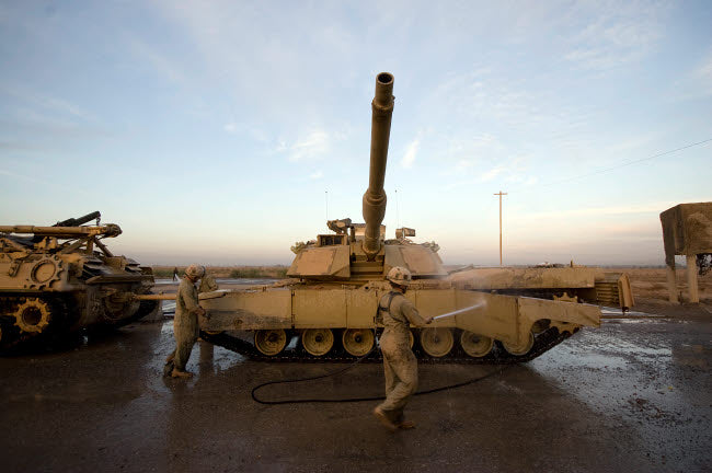 M1 Abrams tank at Camp Warhorse Poster Print by Terry Moore showcasing military power.