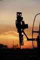 Silhouette of M240G machine gun on UH-60L Black Hawk helicopter at sunset in Baghdad