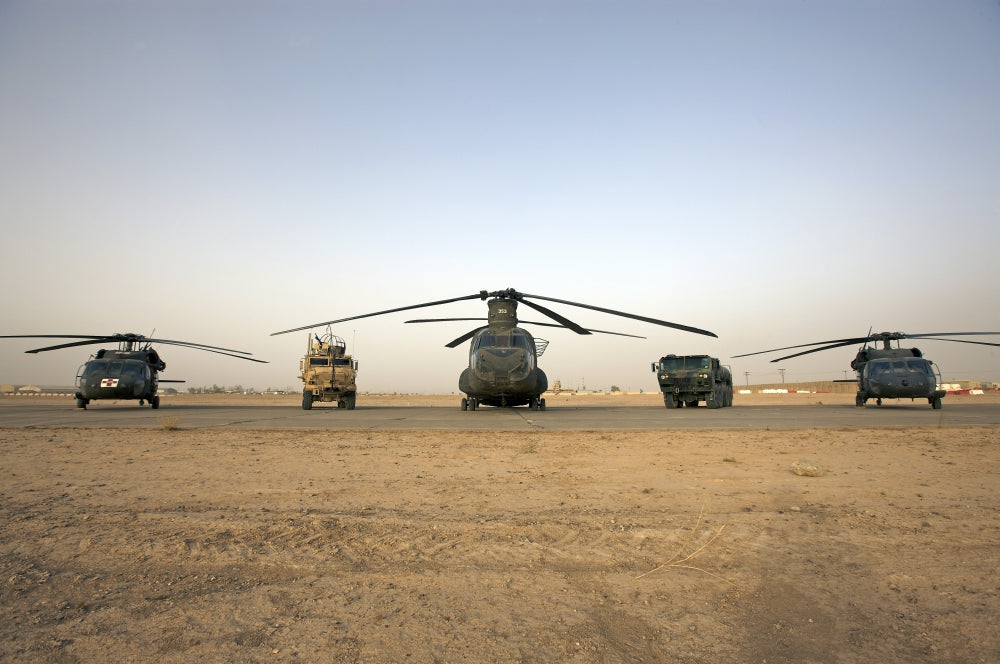 U.S. Military vehicles and aircraft lined up on the taxiway at Camp Speicher, Iraq poster print.