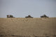 Afghan Army HMMWV and ambulance navigating wadi ridge in Kunduz, Afghanistan poster print.