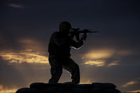 Partially silhouetted U.S. Marine on a bunker in Northern Afghanistan poster print.