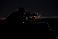 Partially silhouetted U.S. Marine on a bunker in Northern Afghanistan poster print.