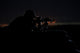 Partially silhouetted U.S. Marine on a bunker in Northern Afghanistan poster print.
