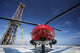 AgustaWestland AW109E helicopter parked on oil rig helipad in Gulf of Mexico.
